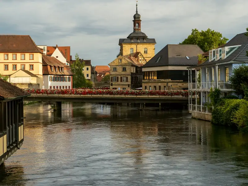 Blumengeschmückte Brücke über die Regnitz mit Blick auf den Rathausturm